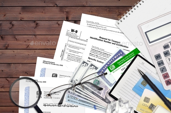 IRS form W-9 Request for taxpayer identification number and certification lies on flat lay office - Stock Photo - Images