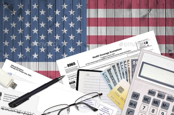 IRS form 8965 Health Coverage Exemptions lies on flat lay office table and ready to fill - Stock Photo - Images