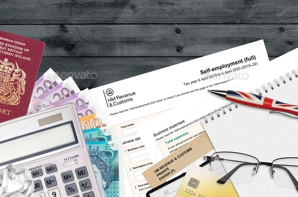 English Tax form sa103 Self-employment from HM revenue and customs lies on table with office items