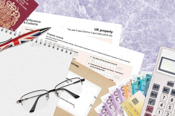 English Tax form sa105 UK Property from HM revenue and customs lies on table with office items