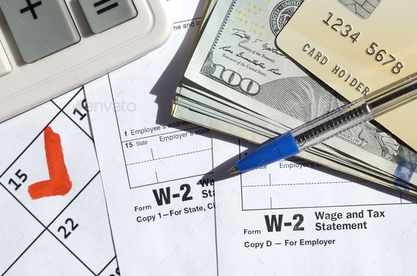 W-2 Wage and Tax statement blank with credit card on dollar bills - Stock Photo - Images