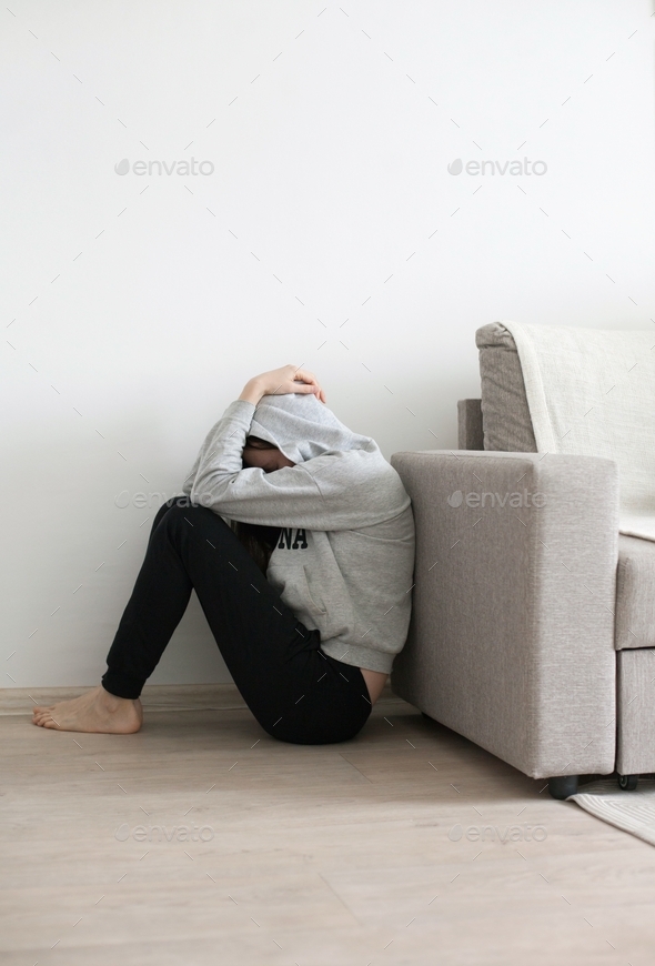 Mental health - woman sitting at the floor having emotional breakdown, stress and emotional burnout