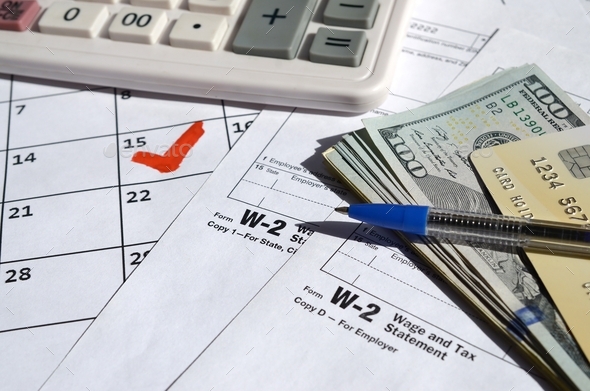 W-2 Wage and Tax statement blank with credit card on dollar bills - Stock Photo - Images