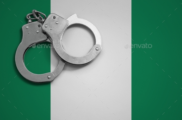 Nigeria flag  and police handcuffs. The concept of crime and offenses in the country. - Stock Photo - Images