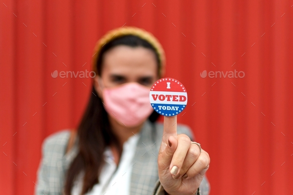 Selective focus image of Woman holding voting sticker with i voted today text.