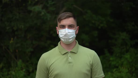 The Young Man Takes Off His Medical Mask and Throws It Away alt