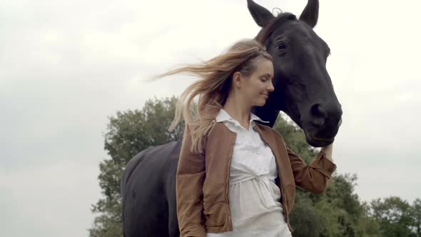 Young Woman Smiles Hugs Black Horse Outdoor Gimbal Steadicam Slow Motion