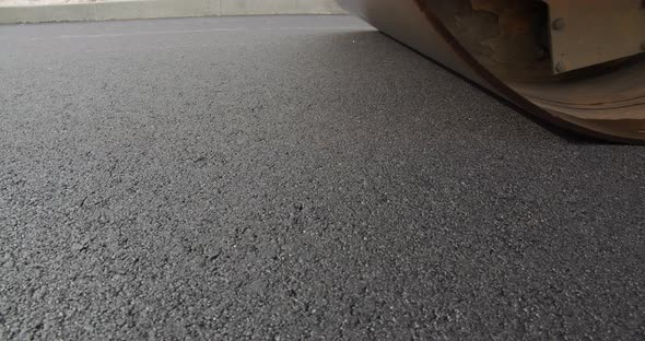 Steamers Smooth Hot Asphalt. Builds A New Road alt