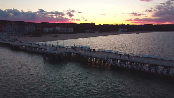 Cinematic pier in the sunset from a bird's eye view. Filming at sunset in Sopot.