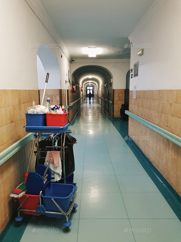 A cleaning trolley in a long hallway.