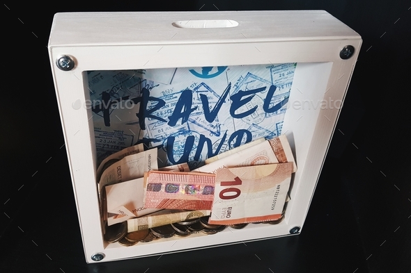 Travel fund piggy bank with euro bills and coins - Stock Photo - Images
