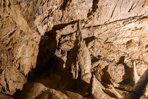 Formations Of Stalactites And Stalagmites Around A Path Inside A Karst