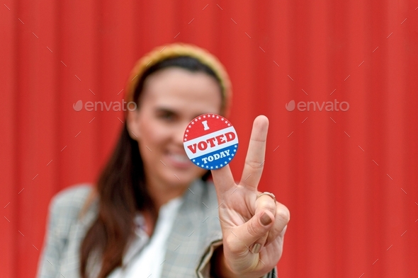 Selective focus image of Woman holding voting sticker with i voted today text.
