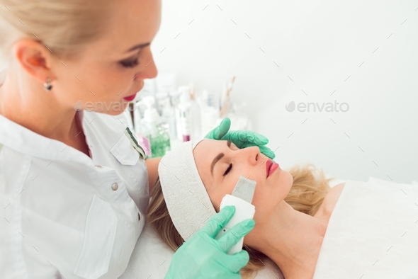 Ultrasound cosmetology scrubber. Face cavitation procedure - Stock Photo - Images