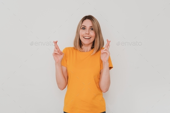 young European woman in casual clothes crossing fingers making wish come true gesture