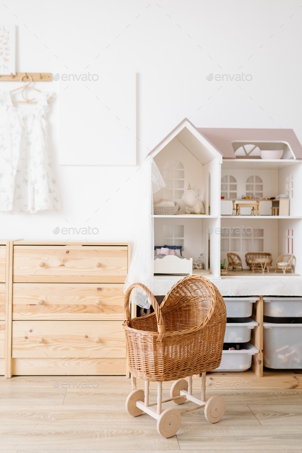 Cozy interior of a children's room, a play area. A chest of drawers, doll house, doll strollers - Stock Photo - Images