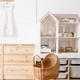 Cozy interior of a children&#39;s room, a play area. A chest of drawers, doll house, doll strollers - PhotoDune Item for Sale
