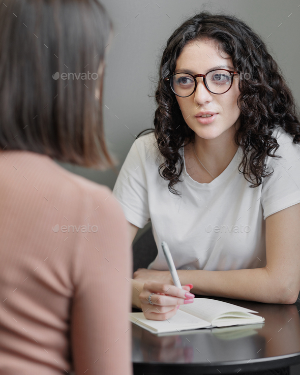 female psychologist holds a meeting with a patient. Help with anxiety and stress, mental health and