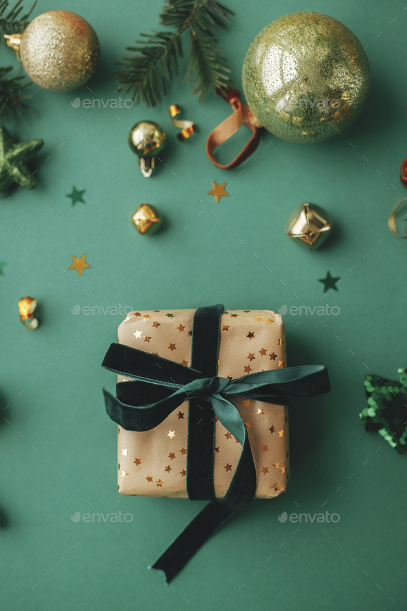Christmas flat lay. Stylish christmas gift wrapped in gold paper and green  ribbon. Merry Christmas Stock Photo by Sonyachny