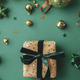 Christmas flat lay. Stylish christmas gift wrapped in gold paper and green  ribbon. Merry Christmas Stock Photo by Sonyachny