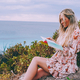 Woman with long hair reading a book outdoors  - PhotoDune Item for Sale