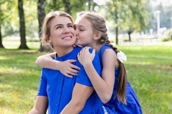 Caucasian Mom And Daughter Are Hugging While Walking In Nature Girl