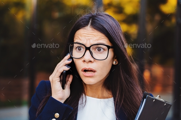 Businesswoman screaming on mobile phone. Having nervous breakdown at work, screaming in anger,
