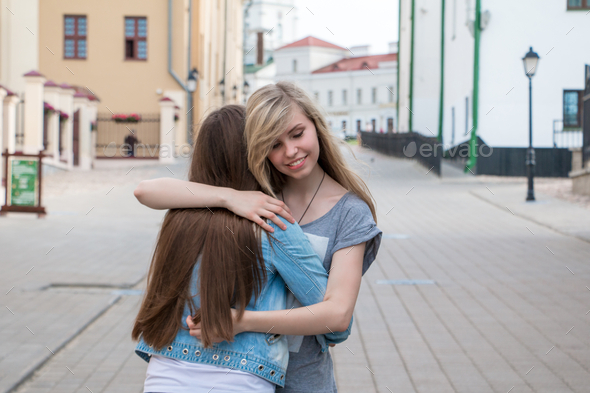 the joy of meeting - girls hugging each other Stock Photo by Tatiana_Mara