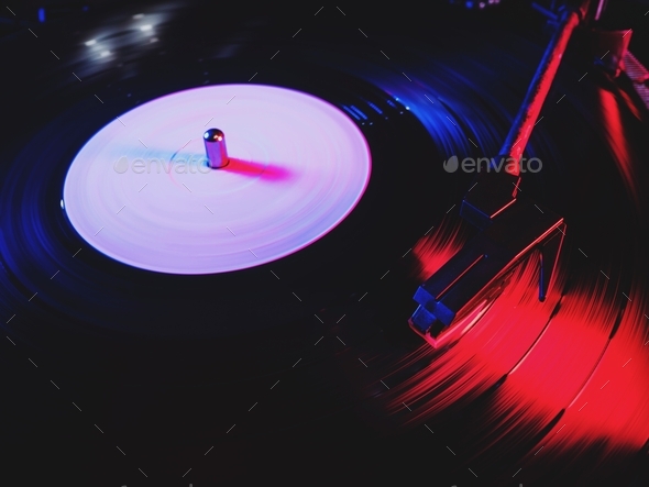 Movie of retro-styled record player spinning vinyl black record. Cinemagraph. Side view. Beautiful