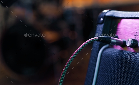 Part of guitar amp with plug in cable. Music concert or recording concept. Copy space - Stock Photo - Images