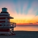 Sunrise on Miami Beach with beautiful sun rays and the silhouette of the lifeguard station  - PhotoDune Item for Sale