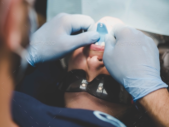 Doctor working with dental milling cnc machine. Spesialist prepare patient teeth for ceramic veneers