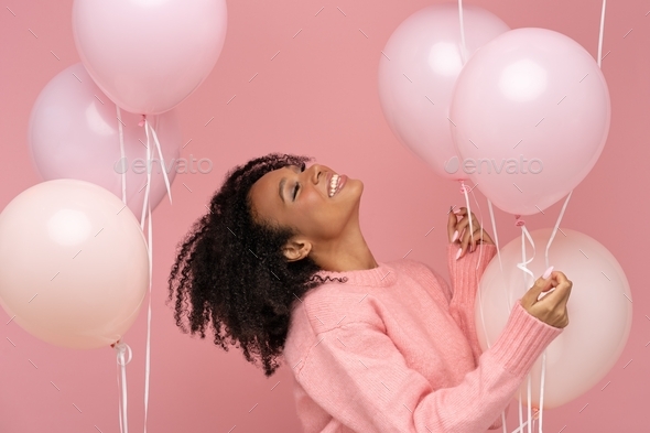 Happy biracial woman with curly hair closed eyes, holding a lot of ...