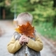 Cute European bald toddler baby in park in fall. Child with large yellow maple leaf - PhotoDune Item for Sale