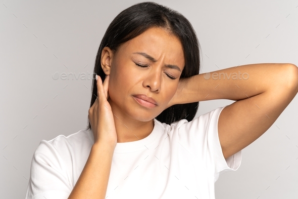 Tired african girl suffer from neck pain, spinal problem, incorrect posture, fibromyalgia. Neck ache