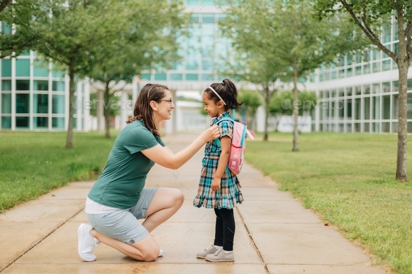 mother-and-daughter-at-school-building-mother-saying-goodbye-to