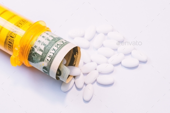 Pills coming out of a pill bottle with a twenty dollar bill inside, medical expense concept