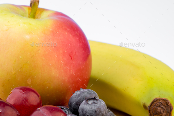 Eating healthy concept, various fruits against white background, apples, bananas, blueberries, grape - Stock Photo - Images