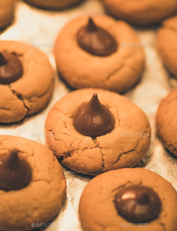 Food and baking, peanut butter blossoms on foil paper  - Stock Photo - Images