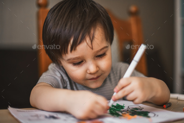 kid draws with markers - Stock Photo - Images