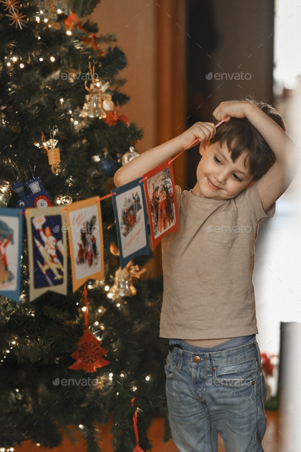 Boys decorate the Christmas tree. - Stock Photo - Images