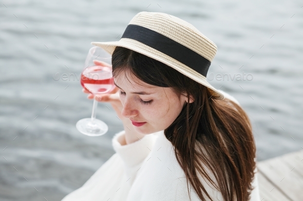 Beautiful girl drinking rose wine at the beach Stock Photo by ...