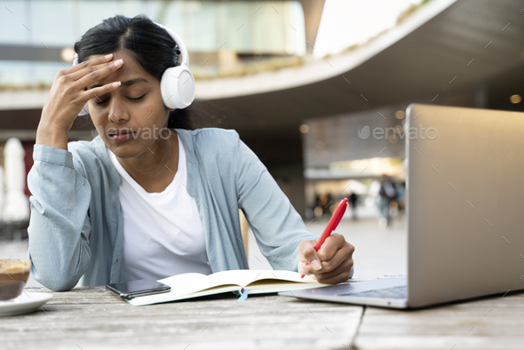 tired Indian student studying, exam preparation. Asian freelancer hard working, missed deadline