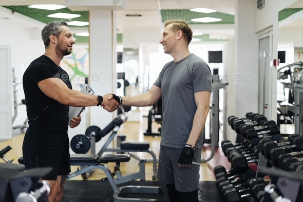 Personal sport coach greeting his client shaking hands. sport and health routine. Support, guidance