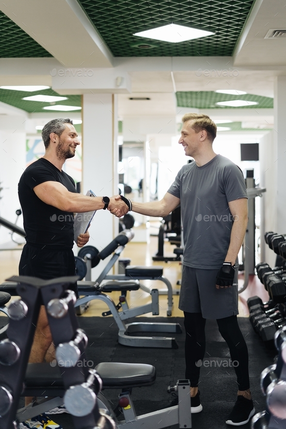 Personal sport coach greeting his client shaking hands. sport and health routine. Support, guidance