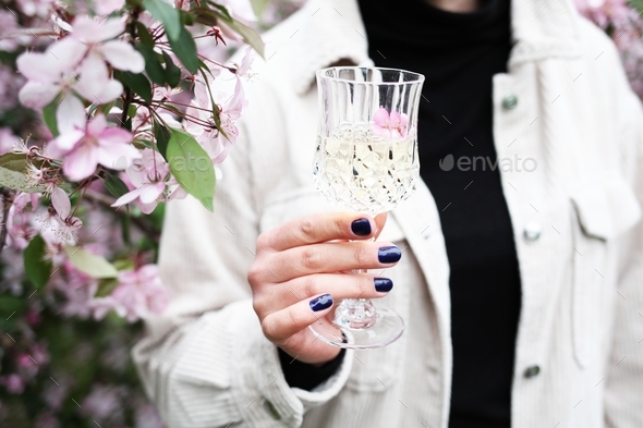 cute pretty young woman outdoors holding glass drinking wine - Stock Photo - Images