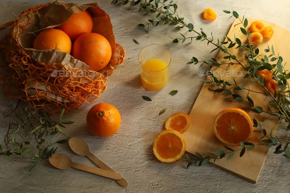 A table with eco-friendly oranges, natural greens and household products made from natural materials