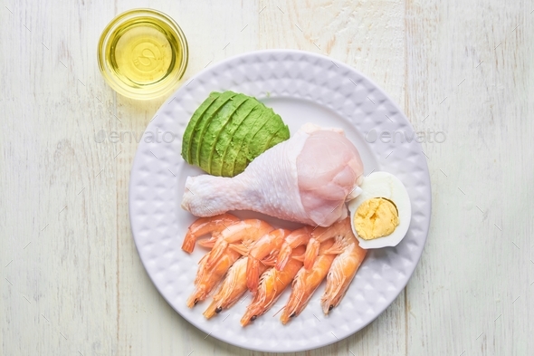Keto diet plate. Fat and protein diet. Healthy eating. Shrimps, chicken meat, egg, avocado