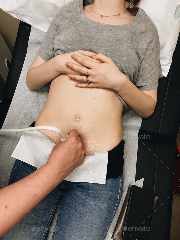 Young woman getting an ultrasound to check on new pregnancy