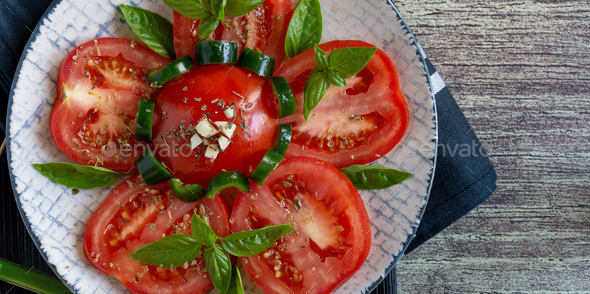 side dish ripe red tomatoes sliced with oil, oregano and garlic - Stock Photo - Images